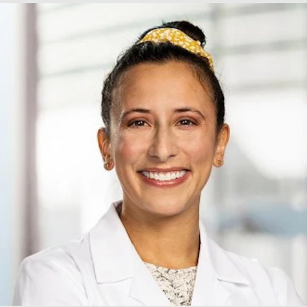Dr. Zuleikha Tyebjee, MD in white coat